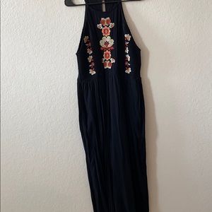 Black romper with floral embellishments